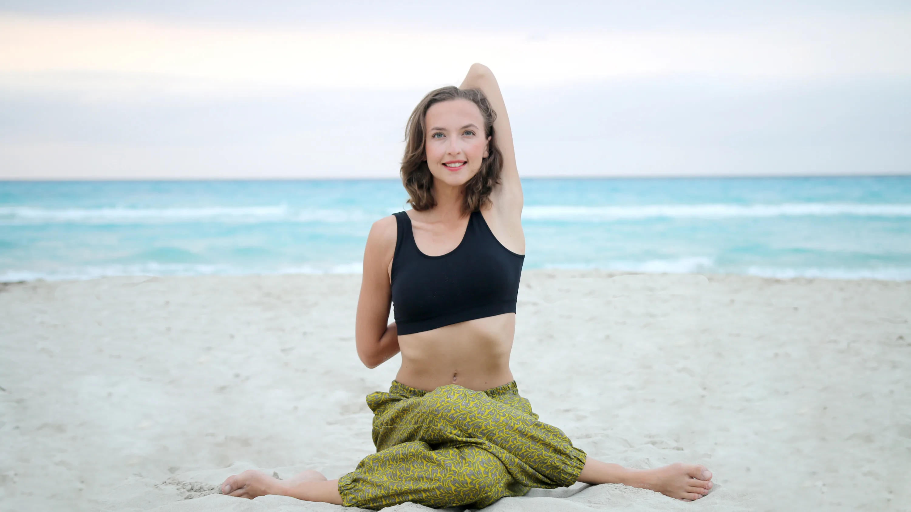 Woman doing yoga on a beach